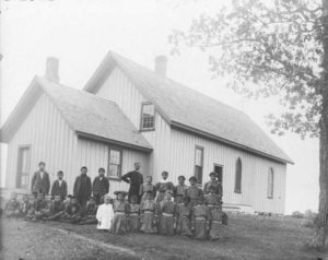 Priest With Children at Indian Boarding School, courtesy Minnesota Historical Society